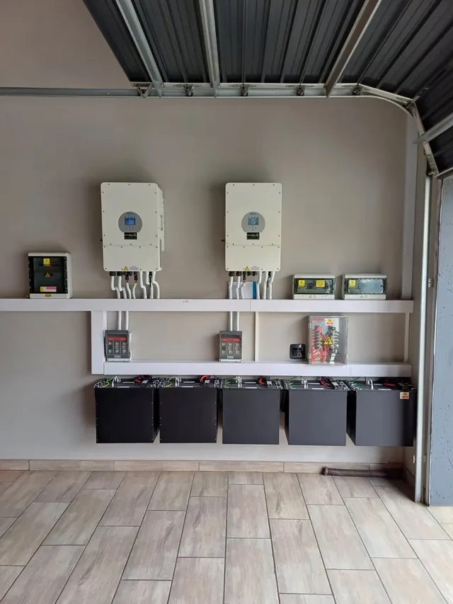 Residential Installation: Twin Deye inverters with battery storage installed in a residential garage utility area.
